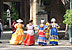 Girls wearing typical dresses from colonial period. Arms Square